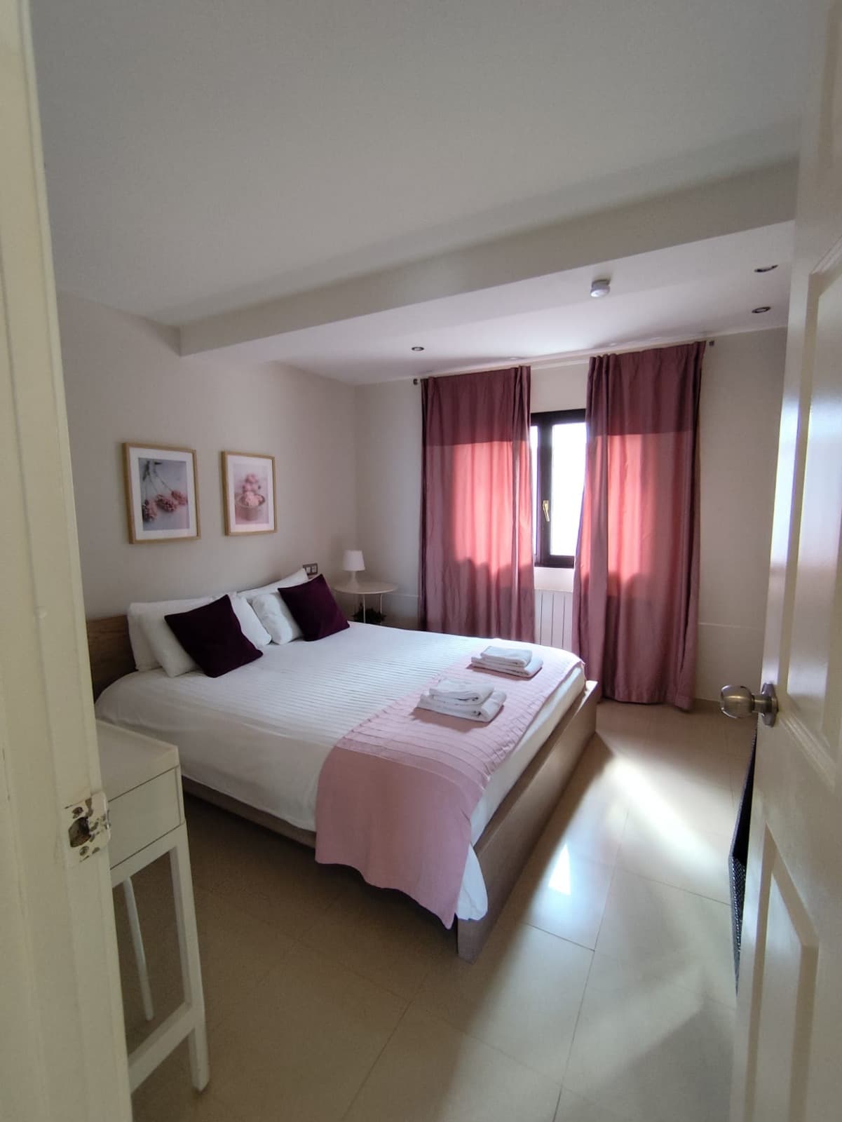 Dormitorio con textiles claros y luz suave